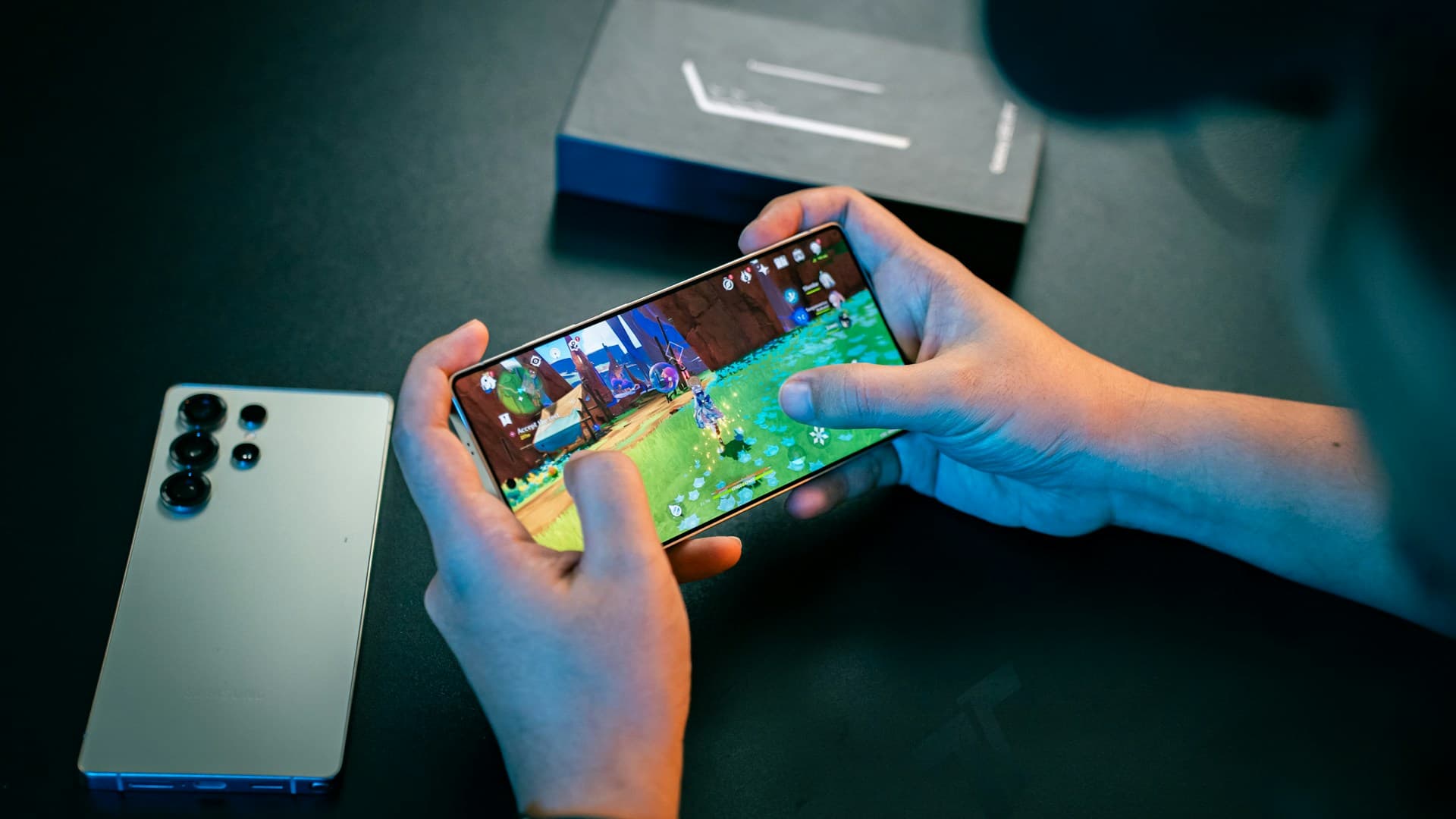 A person sitting at a table with a cell phone